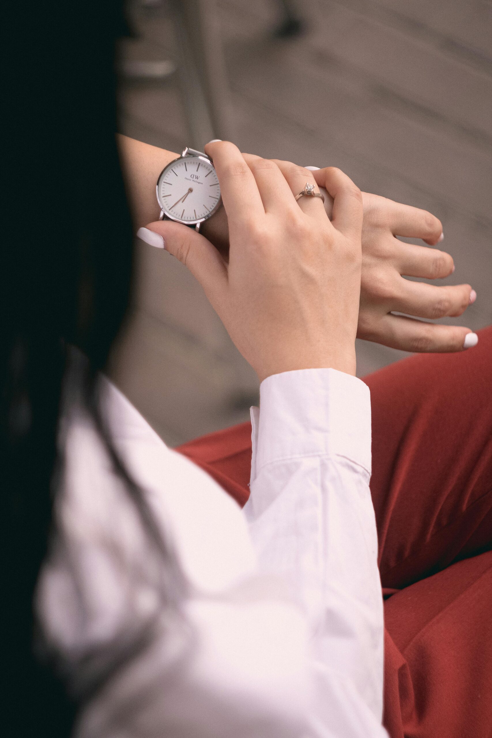 a women looking at a wrist watch, possibly for time management